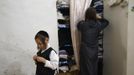 Shmuel Kreus (L), 5, dresses during his family's preparations for the Jewish Sabbath in Jerusalem's Mea Shearim neighbourhood June 29, 2012. The Kreus family are a member of Neturei Karta, a fringe ultra-Orthodox movement within the anti-Zionist bloc. The ultra-Orthodox Jews have gone from being a tiny minority in Israel's mostly secular society to its fastest-growing sector, now about 10 percent of the 7.8 million population. They are exempt from military duty in Israel but draft deferments and state subsidies for the ultra-Orthodox have become a divisive political issue in Israel, where the government must decide a new law by August to ensure more of them do military service. Picture taken June 29, 2012. REUTERS/Ronen Zvulun (JERUSALEM - Tags: RELIGION POLITICS SOCIETY MILITARY) ATTENTION EDITORS - PICTURE 12 OF 21 FOR PACKAGE "ISRAEL'S ULTRA-ORTHODOX". SEARCH "ULTRA-ORTHODOX" FOR ALL PICTURES Published: Čec. 6, 2012, 10:03 dop.