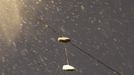 Sneakers are seen hanging from an electricity wire under snow during the nor'easter, also known as a northeaster storm, in Jersey City, New Jersey, November 7, 2012. A wintry storm dropped snow and rain on the U.S. Northeast on Wednesday, bringing dangerous winds and knocking out power in a region where hundreds of thousands were still in the dark after Superstorm Sandy. REUTERS/Eduardo Munoz (UNITED STATES - Tags: ENVIRONMENT DISASTER) Published: Lis. 8, 2012, 2:49 dop.