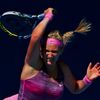 Victoria Azarenka of Belarus hits a return to Johanna Larsson of Sweden during their women's singles match at the Australian Open 2014 tennis tournament in Melbourne