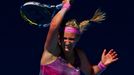 Victoria Azarenka of Belarus hits a return to Johanna Larsson of Sweden during their women's singles match at the Australian Open 2014 tennis tournament in Melbourne Janu