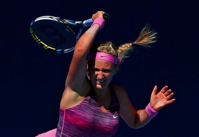 Victoria Azarenka of Belarus hits a return to Johanna Larsson of Sweden during their women's singles match at the Australian Open 2014 tennis tournament in Melbourne Janu