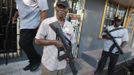 Heavily armed guards hold their weapons outside a business licensed to buy rough diamonds and gold in Georgetown November 20, 2012. In the triangle that connects Venezuela, Brazil and Guyana a huge number of illegal gold and diamonds prospectors or garimpeiros dream of changing their lives overnight by finding a huge bonanza. Picture taken November 20, 2012. REUTERS/Jorge Silva (VENEZUELA - Tags: BUSINESS SOCIETY COMMODITIES) ATTENTION EDITORS: PICTURE 20 OF 20 FOR PACKAGE 'DIAMONDS IN THE JUNGLE'. TO FIND ALL IMAGES SEARCH 'DIAMONDS PROSPECTORS' Published: Pro. 3, 2012, 10 dop.