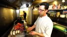 George Kapetanios poses for a photograph in the kitchen of Ta Dilina Greek restaurant in north London where he works as a chef