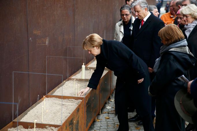 Zapálenou svíčku pak Merkelová položila na památku lidem, kteří zemřeli při pokusu o útěk do někdejšího Západního Berlína. Obětí bylo nejméně 136.