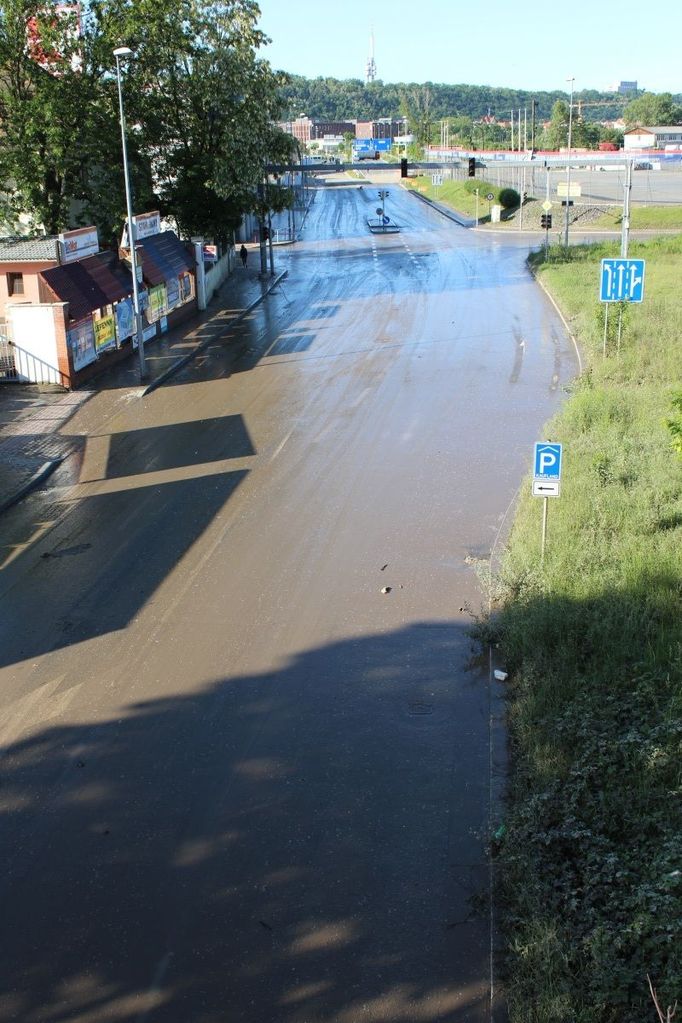 Dole pod mostem bývá touto dobou (mezi osmou a devátou ranní) dopravní zácpa. Teď tu nejezdí nikdo. Hladina Vltavy je ještě moc vysoko, navíc je třeba odklidit nánosy bahna.