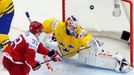 Denmark's Julian Jakobsen (L) tries to score past Sweden's goaltender Anders Nilsson (C) during the second period of their men's ice hockey World Championship group A gam