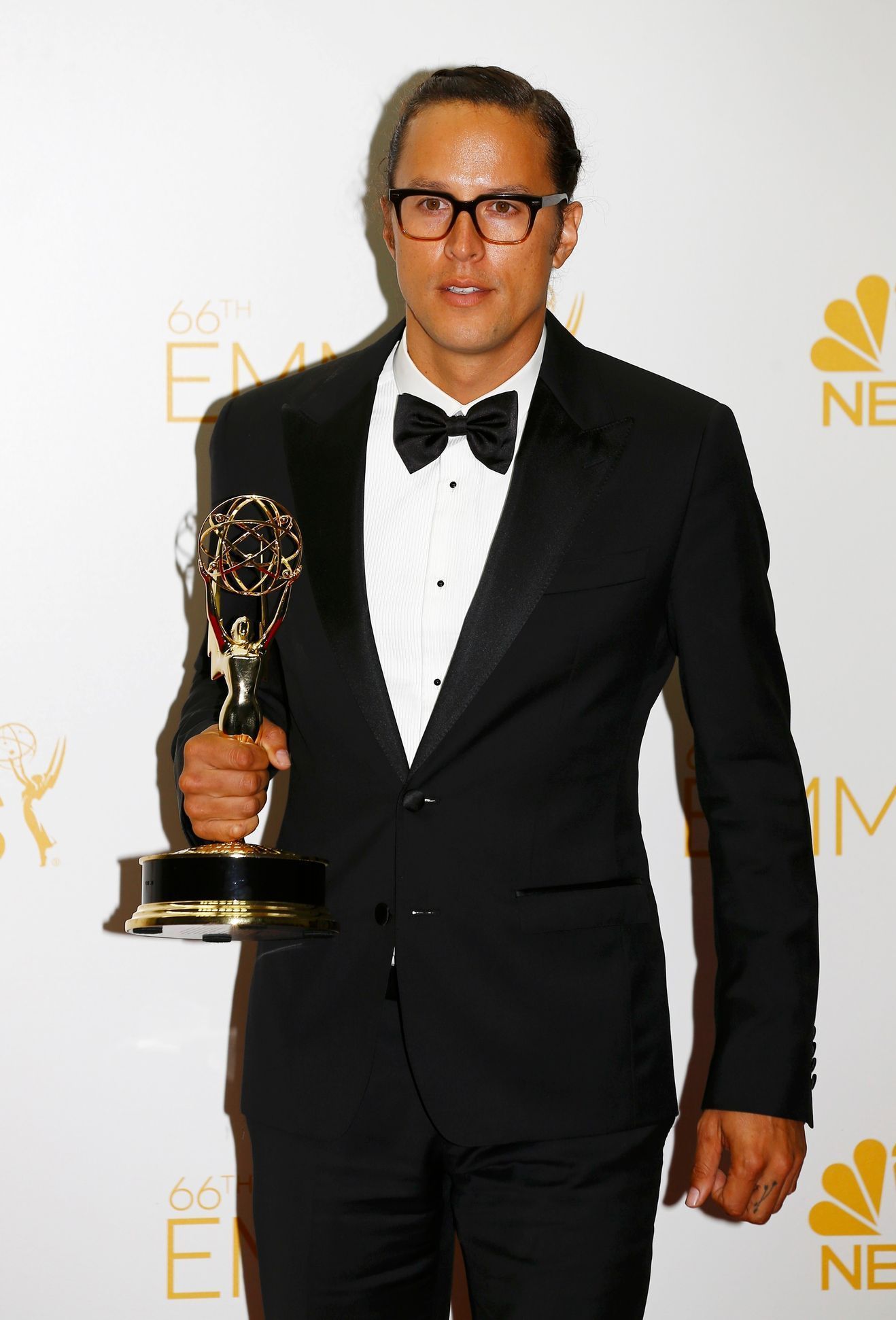 Cary Joji Fukunaga poses with his Outstanding Directing in a Drama Series award at the 66th Primetime Emmy Awards in Los Angeles