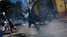 A demonstrator throws a tear gas bomb after military police shot at demonstrators during a protest against the 2014 World Cup, in Sao Paulo June 12, 2014. REUTERS/Nacho D