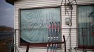 Pairs of skis are seen at an abandoned ski rental shop