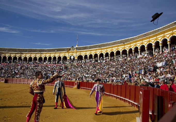 Spanish matador Jose Maria Manzanares throws a hat as he celebrates his performance during a bullfight in Seville