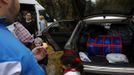 Members of the Gabarri-Valdes family distribute their belongings to different cars after a bulldozer demolished their home at the Spanish gypsy settlement of Puerta de Hierro, in the outskirts of Madrid November 20, 2012. Fifty-four families have been living in Puerta de Hierro, on the banks of the Manzanares river for over 50 years. Since the summer of 2010, the community has been subject to evictions on the grounds that the dwellings are illegal. Families, whose homes have been demolished, move in with relatives whose houses still remain while the debris keeps piling up around them as more demolitions take place. REUTERS/Susana Vera (SPAIN - Tags: CIVIL UNREST BUSINESS CONSTRUCTION) Published: Lis. 20, 2012, 5:12 odp.