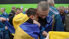 Ukrainian prisoners of war (POWs) gather after a swap at an unknown location in Ukraine