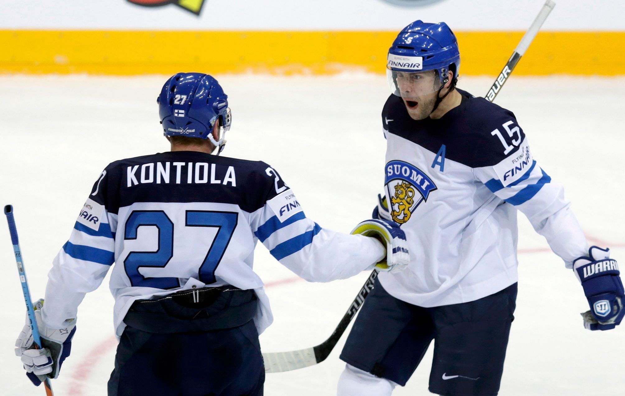 Finland's Ruutu celebrates with his teammate Kontiola after scoring a goal against the Czech Republic during their Ice Hockey World Championship quarterfinal game at the O2 arena in Prague