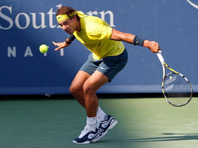 Rafael Nadal of Spain hits a return ball to Tomas Berdych of the Czech Republic in their semifinal round match at the Men's Cincinnati Open tennis tournament in Cincinnat