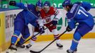 Jakub Petruzalek of the Czech Republic (C) battles for the puck with Italy's Marco Insam (L) and Davide Nicoletti (R) during the second period of their men's ice hockey W