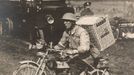 A British soldier rides a motorbike with a basket of pigeons on his back, on his way to delivering them to the frontline on the Western Front in this 1916 handout picture