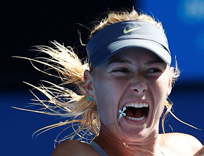 FILE PHOTO: Maria Sharapova of Russia hits a return to Kirsten Flipkens of Belgium during their women's singles match at the Australian Open tennis tournament in Melbourn