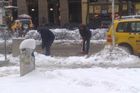 Úklid rozbředlého sněhu na parkovacích místech taxikářských aut na Václavském náměstí.