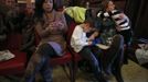 Theresa Volpe (2nd R) sits with her daughter Ava (R) and son Jaidon (3rd R) while her partner Mercedes Santos responds to emails as they wait for the start of an an Illinois Senate Executive Committee hearing on same-sex marriages at the State Legislature in Springfield, Illinois, January 3, 2013. Santos and Volpe are a same-sex couple raising two of their biological children as they struggle to get same-sex marriages passed into law in Illinois. Picture taken on January 3, 2013. REUTERS/Jim Young (UNITED STATES - Tags: SOCIETY) Published: Bře. 25, 2013, 6:07 odp.