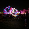 Concertgoers throw illuminated hula hoops during the performance by Canadian electrofunk duo Chromeo at the Coachella Valley Music and Arts Festival in Indio