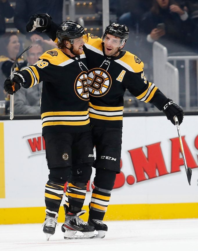 Oct 17, 2019; Boston, MA, USA; Boston Bruins center Patrice Bergeron (37) celebrates with right wing David Pastrňák (88) after scoirng a goal during the second period aga