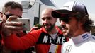 McLaren Formula One driver Fernando Alonso of Spain poses for a selfie with a supporter during the second testing session ahead of the upcoming season at the Circuit Barc