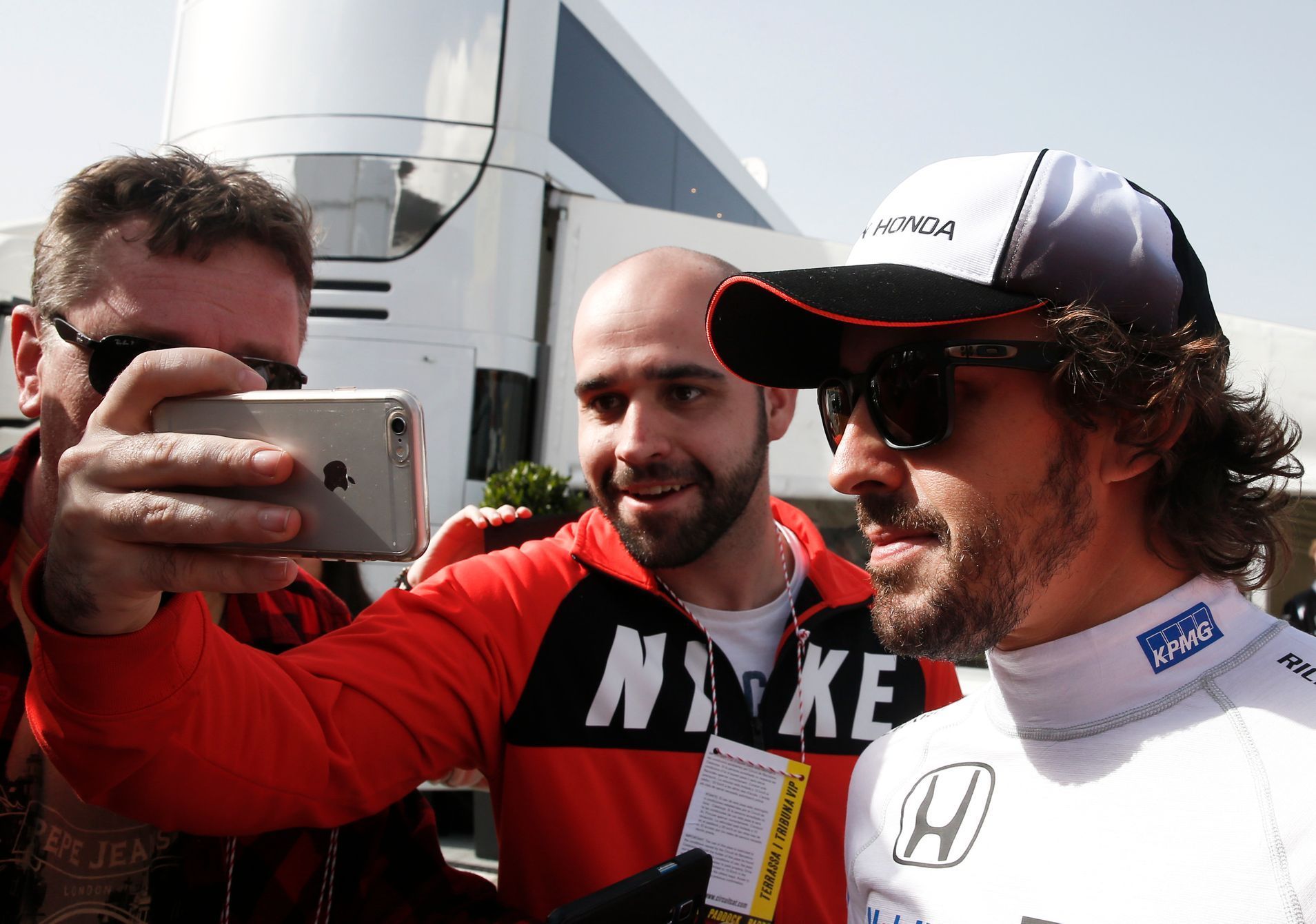 McLaren Formula One driver Alonso of Spain poses for a selfie with a supporter during the second testing session ahead of the upcoming season at the Circuit Barcelona-Catalunya in Montmelo