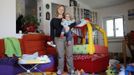 Francesca Baldi, 32, poses for a picture as she takes care of a seven month-old baby in a private household in Rome May 11, 2012. Baldi studied for five years at university in Pisa where she received a degree and a doctorate in literature and philosophy. She hoped to find a job as a teacher but has been working as a childminder for five months.