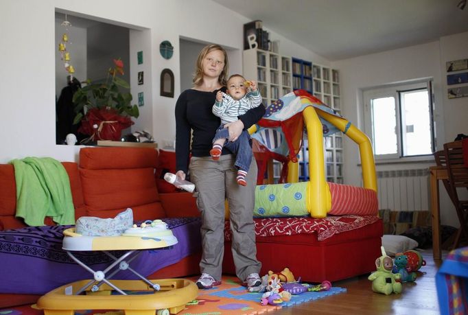 Francesca Baldi, 32, poses for a picture as she takes care of a seven month-old baby in a private household in Rome May 11, 2012. Baldi studied for five years at university in Pisa where she received a degree and a doctorate in literature and philosophy. She hoped to find a job as a teacher but has been working as a childminder for five months.