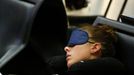 A passenger rests, wrapped in the blankets of German air carrier Lufthansa as they wait for their transfer at the Fraport airport in Frankfurt, September 4, 2012. Lufthansa passengers face widespread flight disruption after cabin crew representatives said they continue a series of strikes over pay and cost-cutting measures at Germany's largest airline. The UFO union, which represents around two-thirds of Lufthansa's 19,000 cabin crew, late on Thursday called on its members to strike from 0400 GMT to 1500 GMT on Tuesday in Frankfurt and Berlin's Tegel airport from 0300-1100 GMT. REUTERS/Kai Pfaffenbach (GERMANY - Tags: BUSINESS EMPLOYMENT CIVIL UNREST TRANSPORT) Published: Zář. 4, 2012, 8:41 dop.