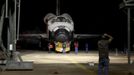 Workers take photos before the space shuttle Discovery is lifted at the Mate Demate Facility at Kennedy Space Center