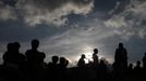 People wait for the coffins of 8-year-old Evelyn Yanisa Saquij Bin and 13-year-old Juan Armando Coy Cal, who were killed by a man in their classrooms, to arrive at the municipal cemetery in Tactic, in the Alta Verapaz region, some 189 km (117 miles) from Guatemala City, September 14, 2012. Angry villagers in Guatemala killed a man by setting fire to him after he hacked Saquij Bin and Armando Coy Cal to death with a machete in a school on September 12. The two children were buried today in a municipal cemetery. REUTERS/Jorge Dan Lopez (GUATEMALA - Tags: CRIME LAW SOCIETY) Published: Zář. 15, 2012, 5:05 dop.