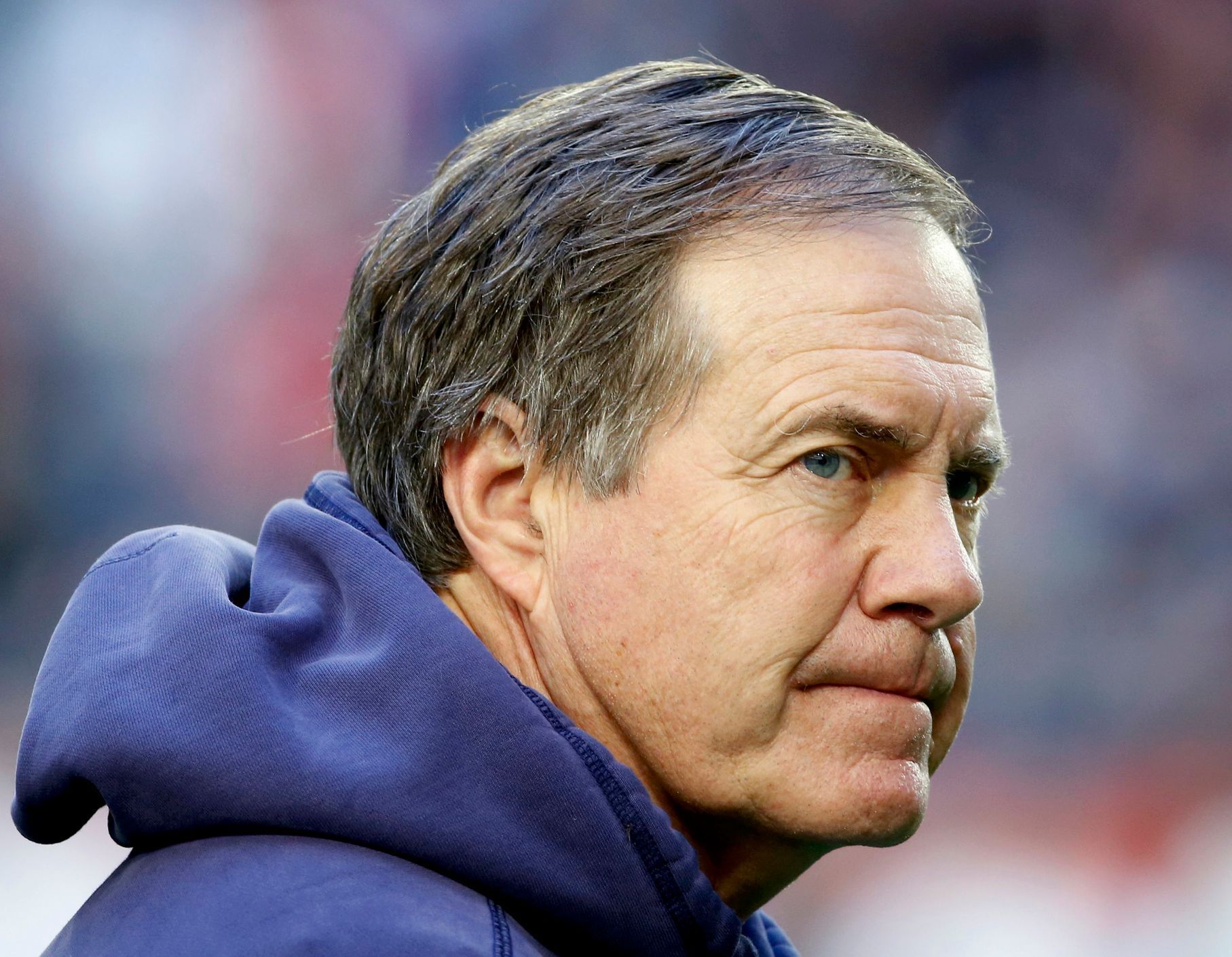 New England Patriots head coach Bill Belichick looks over his team during warm-ups ahead of the start of the NFL Super Bowl XLIX football game against the Seattle Seahawks in Glendale