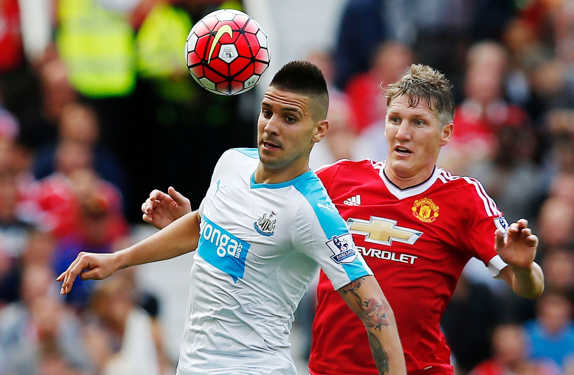 Newcastle's Aleksandar Mitrovic in action with Manchester United's Bastian Schweinsteiger