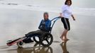 File photo dated 16/09/10 of French limbless swimmer Philippe Croizon is helped into the sea by team member Valerie Carbonnel during a training session in Folkestone, Kent. Philippe Croizon today became the first limbless person to swim the Channel.