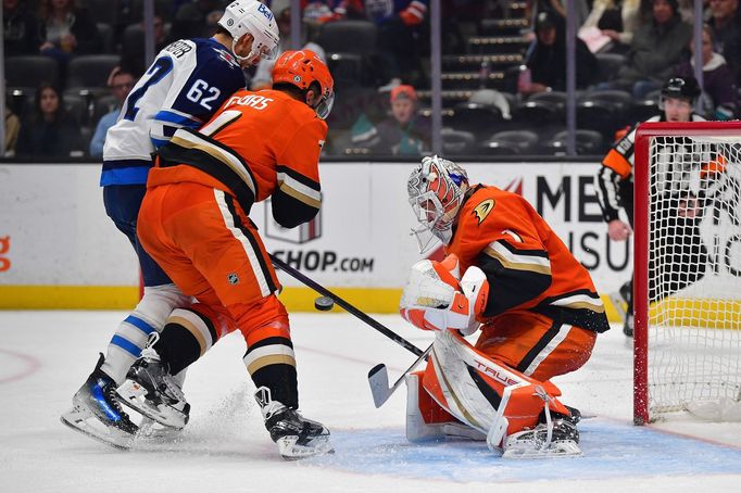 Dec 18, 2024; Anaheim, California, USA; Anaheim Ducks goaltender Lukas Dostal (1) blocks a shot as defenseman Radko Gudas (7) helps defend against Winnipeg Jets right win