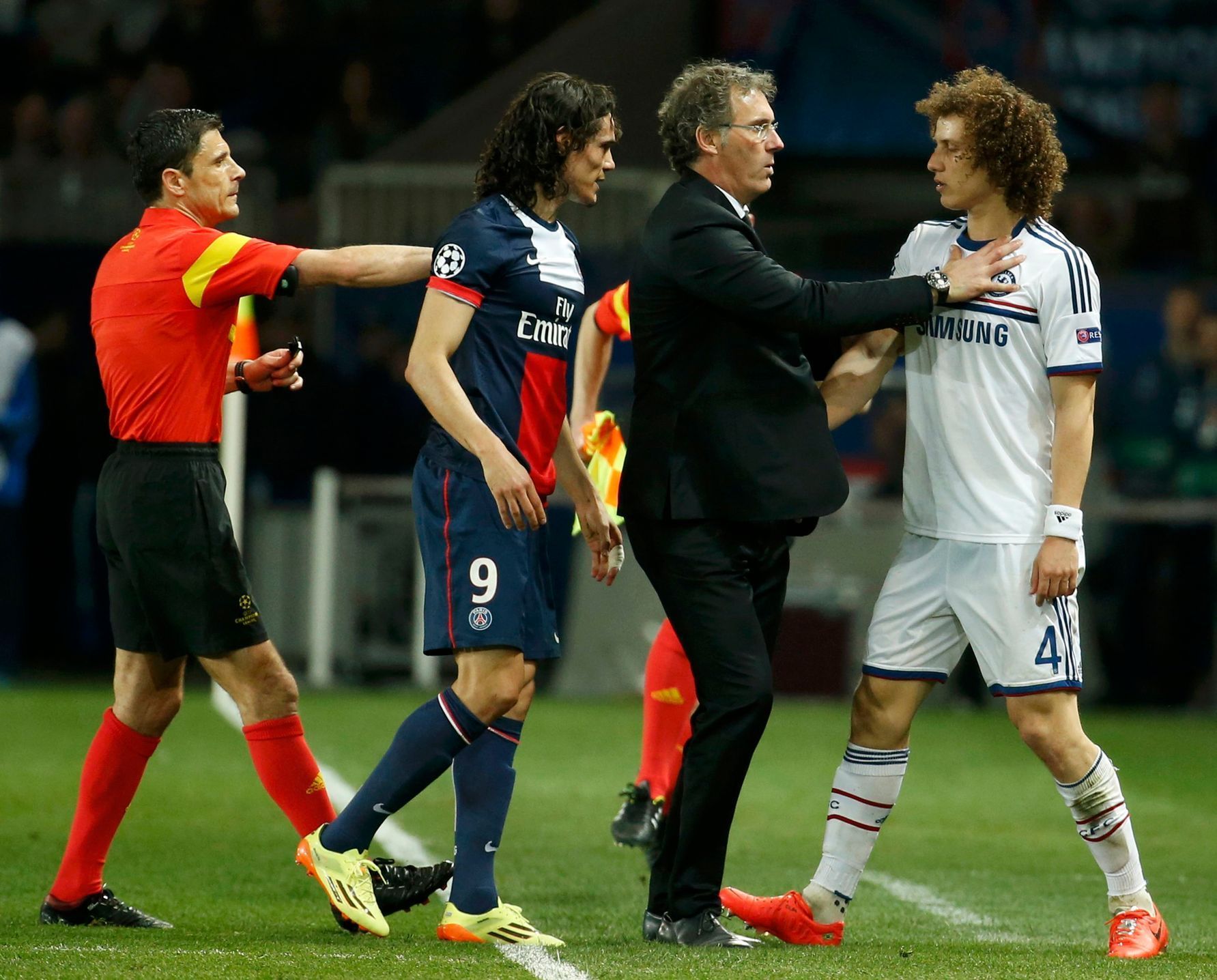 Paris St Germain coach Blanc reacts as Cavani struggles with Chelsea's Luiz during their Champions League quarter-final first leg soccer match at the Parc des Princes Stadium in Paris