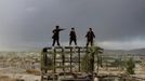 RNPS IMAGES OF THE YEAR 2012 - Afghan boys play on a destroyed car at a hilltop in Kabul October 18, 2012. REUTERS/Mohammad Ismail (AFGHANISTAN - Tags: SOCIETY TPX IMAGES OF THE DAY) Published: Pro. 4, 2012, 1:11 dop.