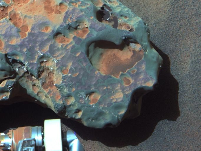 Close-up of a Meteorite - 'Oileán Ruaidh' (False Color) This is an image of the meteorite that NASA's Mars Exploration Rover Opportunity found and examined in September 2010. Opportunity's cameras first revealed the meteorite in images taken on Sol 2363 (Sept. 16, 2010), the 2,363rd Martian day of the rover's mission on Mars. This view was taken with the panoramic camera on Sol 2371 (Sept. 24, 2010). The science team used two tools on Opportunity's arm -- the microscopic imager and the alpha particle X-ray spectrometer -- to inspect the rock's texture and composition. Information from the spectrometer confirmed that the rock is a nickel-iron meteorite. The team informally named the rock "Oileán Ruaidh" (pronounced ay-lan ruah), which is the Gaelic name for an island off the coast of northwestern Ireland. Opportunity departed Oileán Ruaidh and resumed its journey toward the mission's long-term destination, Endeavour Crater, on Sol 2374 (Sept. 28, 2010) with a drive of about 100 meters (328 feet). The component images were taken through three Pancam filters admitting wavelengths of 753 nanometers, 535 nanometers and 432 nanometers. This view is presented in false color to make some differences between materials easier to see. Credit: NASA/JPL-Caltech/Cornell University