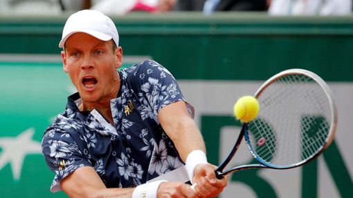 Tomas Berdych of the Czech Republic returns the ball to Ernests Gulbis of Latvia during their men's quarter final match at the French Open Tennis tournament at the Roland