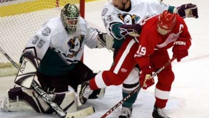 Anaheimský gólman Jean-Sebastien Giguere (vlevo) a bek Ruslan Salej brání detroitského kapitána Steva Yzermana, který odehrál 1500. zápas NHL.