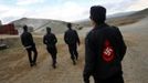 Members of the Mongolian neo-Nazi group Tsagaan Khass walk through a quarry, where they questioned a worker, southwest of Ulan Bator June 23, 2013. The group has rebranded itself as an environmentalist organisation fighting pollution by foreign-owned mines, seeking legitimacy as it sends Swastika-wearing members to check mining permits. Over the past years, ultra-nationalist groups have expanded in the country and among those garnering attention is Tsagaan Khass, which has recently shifted its focus from activities such as attacks on women it accuses of consorting with foreign men to environmental issues, with the stated goal of protecting Mongolia from foreign mining interests. This ultra-nationalist group was founded in the 1990s and currently has 100-plus members. Picture taken June 23, 2013. REUTERS/Carlos Barria (MONGOLIA - Tags: POLITICS ENVIRONMENT BUSINESS SOCIETY EMPLOYMENT) ATTENTION EDITORS: PICTURE 21 OF 25 FOR PACKAGE 'MONGOLIA'S ENVIRONMENTAL NEO-NAZIS'. TO FIND ALL IMAGES SEARCH 'TSAGAAN KHASS' Published: Čec. 2, 2013, 9:58 dop.