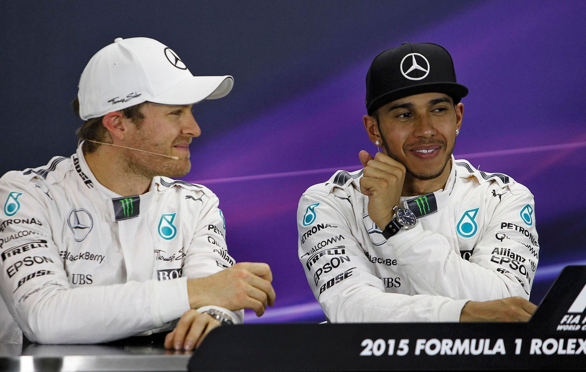 Mercedes Formula One driver Nico Rosberg of Germany and team mate Lewis Hamilton of Britain attend a news conference following the qualifying session of the Australian F1 Grand Prix at the Albert Park