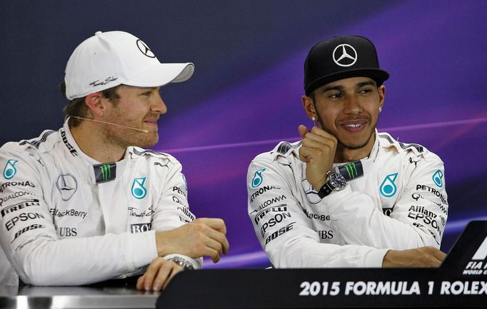 Mercedes Formula One driver Nico Rosberg of Germany (L) and team mate Lewis Hamilton of Britain attend a news conference following the qualifying session of the Australia