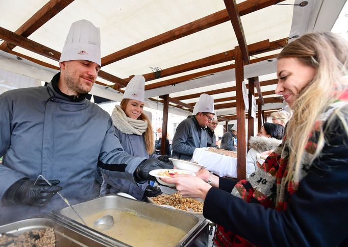 Pražský primátor Zdeněk Hřib nalévá na Staroměstském náměstí rybí polévku.