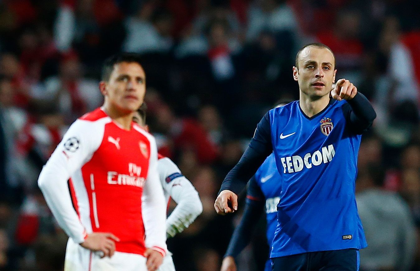 Football: Monaco's Dimitar Berbatov celebrates scoring their second goal as Arsenal's Alexis Sanchez looks on dejected