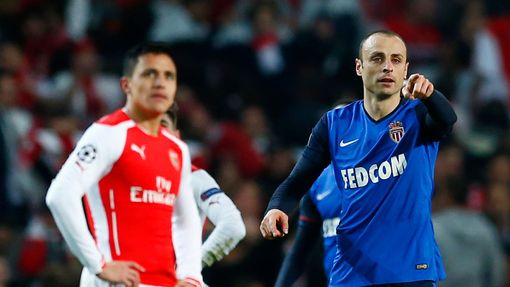Football: Monaco's Dimitar Berbatov celebrates scoring their second goal as Arsenal's Alexis Sanchez looks on dejected
