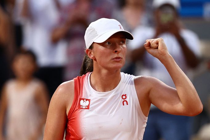 Paris 2024 Olympics - Tennis - Women's Singles Third Round - Roland-Garros Stadium, Paris, France - July 30, 2024. Iga Swiatek of Poland celebrates after winning her matc