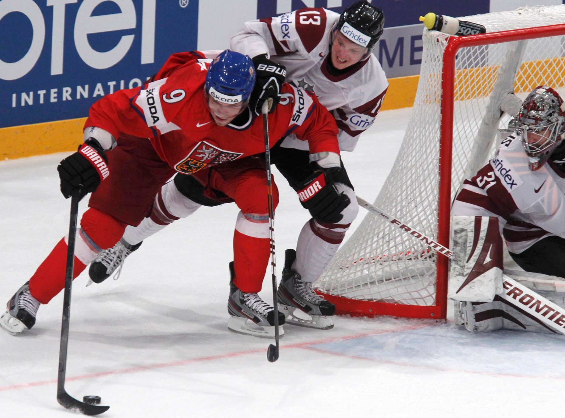 Michálek bojuje o puk s Galvinsem před brankou Masalskise v utkání Česko - Lotyšsko