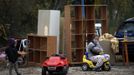 Aroa Gabarri Valdes, 12, sits next to her family belongings as her cousin Andy plays nearby after a bulldozer demolished her home at the Spanish gypsy settlement of Puerta de Hierro, in the outskirts of Madrid November 20, 2012. Fifty-four families have been living in Puerta de Hierro, on the banks of the Manzanares river for over 50 years. Since the summer of 2010, the community has been subject to evictions on the grounds that the dwellings are illegal. Families, whose homes have been demolished, move in with relatives whose houses still remain while the debris keeps piling up around them as more demolitions take place. REUTERS/Susana Vera (SPAIN - Tags: CIVIL UNREST BUSINESS CONSTRUCTION) Published: Lis. 20, 2012, 5:07 odp.